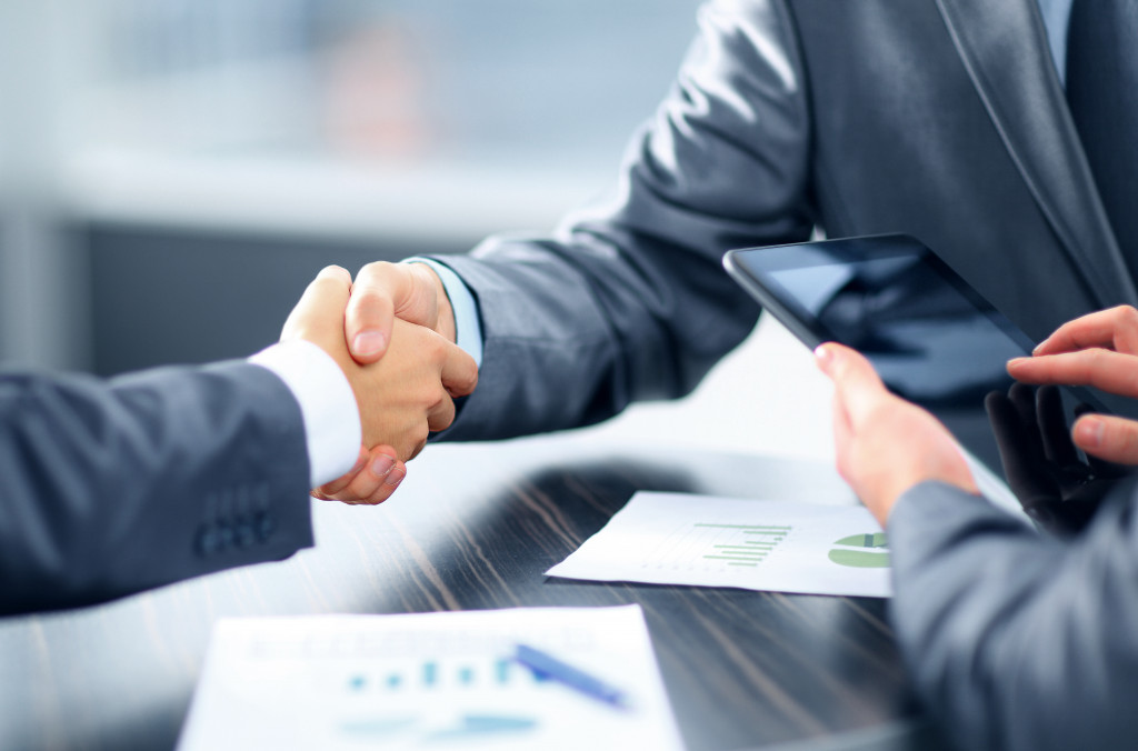 Two businessmen shaking hand in an office