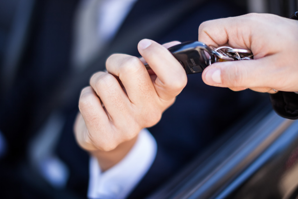 A businessman taking the car keys from another person's hand